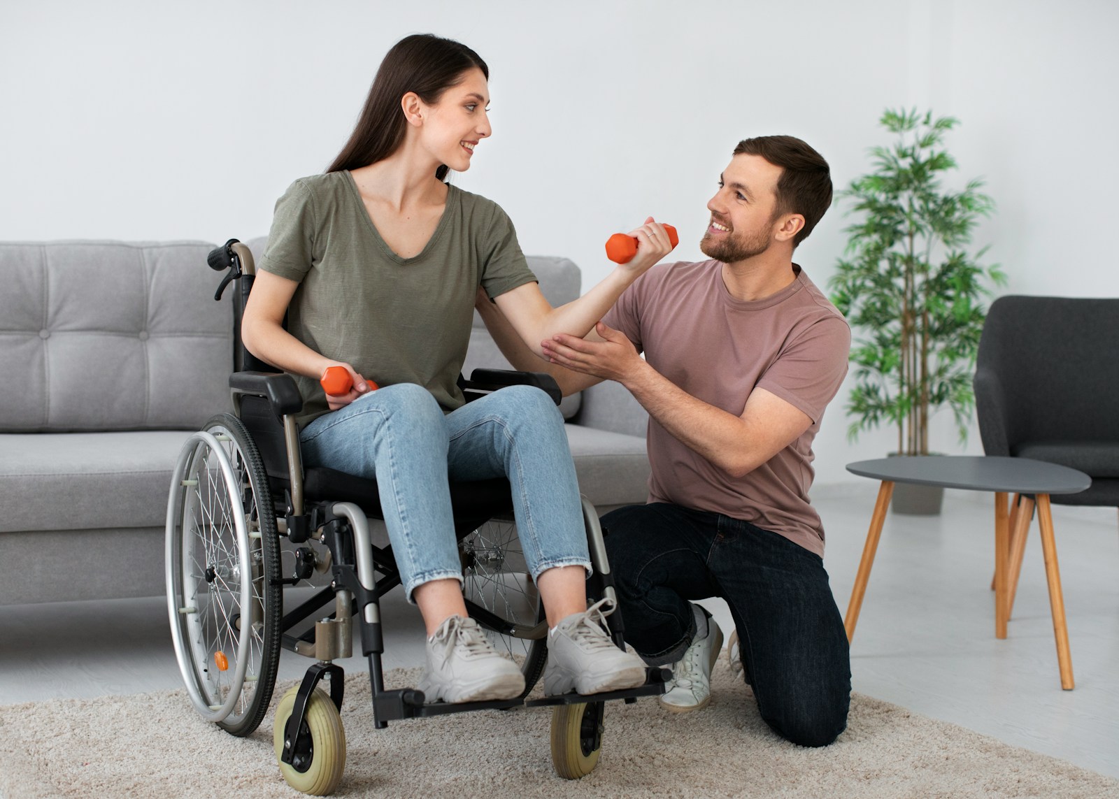 A man in a wheel chair being pushed by a woman, disability